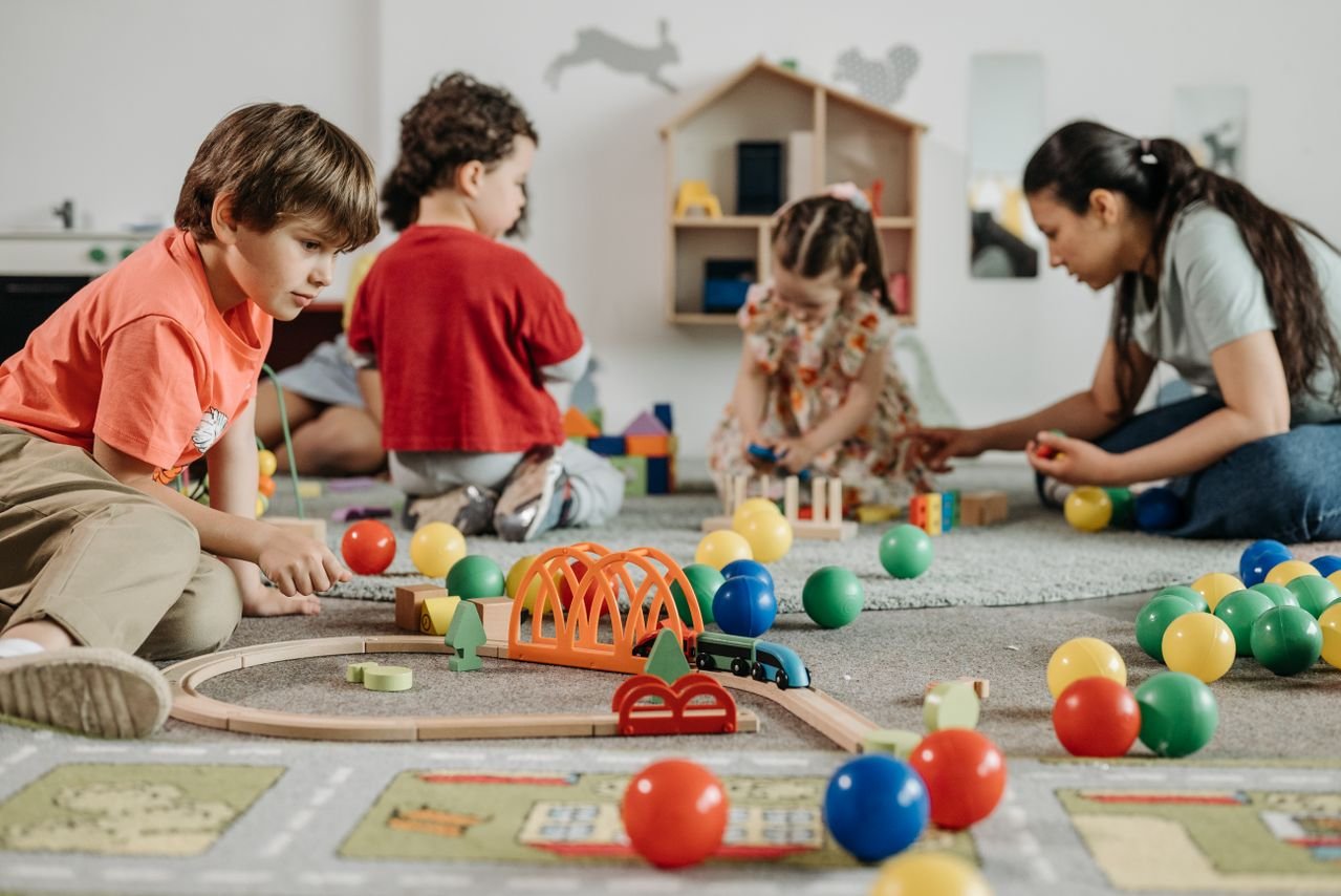 Nursery kids playing with toys